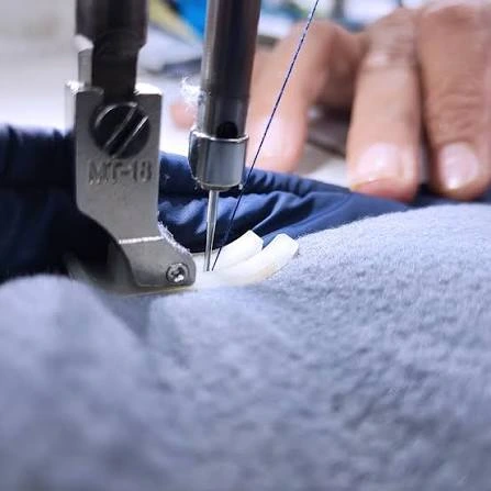 Machinist stitching the side seams of a GAA jersey